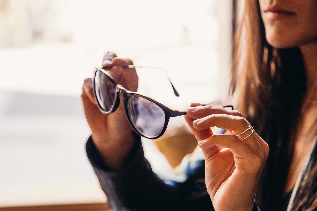 woman looking at glasses